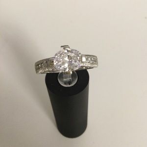 Sterling silver solitaire with Chanel set stones on sides. Vanna K in size 10